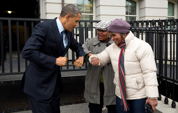 Barack Obama bumps elbows with women in the street